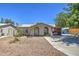 Tan single story home with a spacious yard and mature tree at 7201 W Alvarado Rd, Phoenix, AZ 85035