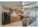 Galley kitchen with wood cabinets and black appliances at 7201 W Alvarado Rd, Phoenix, AZ 85035