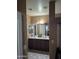 Double vanity bathroom with dark wood cabinets and tile floors at 7417 W Park St, Laveen, AZ 85339