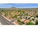 Aerial view of houses, roads, and desert landscape with mountains in background at 7635 W Rock Springs Dr, Peoria, AZ 85383