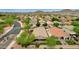 Aerial view of houses with desert landscaping, a community entrance, and mountain views at 7635 W Rock Springs Dr, Peoria, AZ 85383