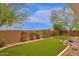 Artificial turf backyard with landscaping and a wall at 7635 W Rock Springs Dr, Peoria, AZ 85383