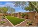 Landscaped backyard featuring artificial turf and garden at 7635 W Rock Springs Dr, Peoria, AZ 85383