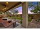 Relaxing covered patio overlooking a manicured lawn at 7635 W Rock Springs Dr, Peoria, AZ 85383