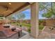 Relaxing covered patio with seating area, overlooking a grassy backyard at 7635 W Rock Springs Dr, Peoria, AZ 85383