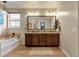 Bathroom with double vanity and a large mirror at 7635 W Rock Springs Dr, Peoria, AZ 85383