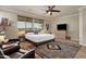 Bright bedroom with large bed and TV at 7635 W Rock Springs Dr, Peoria, AZ 85383