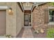 Front entry with a stone accent wall and wrought iron gate at 7635 W Rock Springs Dr, Peoria, AZ 85383