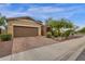 House exterior featuring a brown garage door and well-manicured landscaping at 7635 W Rock Springs Dr, Peoria, AZ 85383