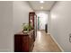 Bright hallway with tile flooring and a wooden display cabinet at 7635 W Rock Springs Dr, Peoria, AZ 85383