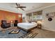 Main bedroom with a cozy sitting area and ceiling fan at 7635 W Rock Springs Dr, Peoria, AZ 85383