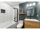 Modern bathroom features a sleek vanity, tiled walls, updated fixtures, and a shower-tub combination with glass screen at 8024 E Hubbell St, Scottsdale, AZ 85257