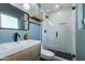 Stylish bathroom features a floating wood vanity, sleek black fixtures, and a glass-enclosed shower with black tile floor at 8024 E Hubbell St, Scottsdale, AZ 85257