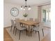 Bright dining room features a modern chandelier and a round mirror accenting the neutral wall at 8024 E Hubbell St, Scottsdale, AZ 85257