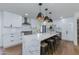 Modern kitchen with a large island, pendant lighting, white cabinets, and stainless steel appliances at 8024 E Hubbell St, Scottsdale, AZ 85257