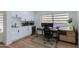 Well-lit home office featuring custom cabinetry, a built-in desk, and a window with views of the exterior at 8024 E Hubbell St, Scottsdale, AZ 85257