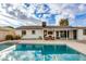 Backyard pool with clear blue water, plenty of patio space, palm trees, and an outdoor living area at 8024 E Hubbell St, Scottsdale, AZ 85257