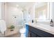 Updated bathroom, featuring a navy vanity and walk-in shower at 8413 E Sheridan St, Scottsdale, AZ 85257