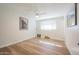 Spacious bedroom with wood-look floors and large window at 8413 E Sheridan St, Scottsdale, AZ 85257