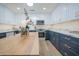 Modern kitchen with white and blue cabinets, marble countertops, and stainless steel appliances at 8413 E Sheridan St, Scottsdale, AZ 85257