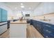 Updated kitchen featuring teal fridge, white and blue cabinets, and a marble center island at 8413 E Sheridan St, Scottsdale, AZ 85257