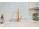 Modern kitchen sink with gold faucet and white marble countertop at 8413 E Sheridan St, Scottsdale, AZ 85257