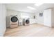 Bright laundry room with washer, dryer, and cabinets at 8413 E Sheridan St, Scottsdale, AZ 85257