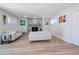 Living room with fireplace, light sofas, and hardwood floors at 8413 E Sheridan St, Scottsdale, AZ 85257