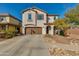 Two-story home with a two-car garage and a well-maintained front yard featuring desert landscaping at 852 E Gary Ln, Phoenix, AZ 85042