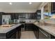 Kitchen featuring stainless steel appliances, dark cabinets and granite countertops at 852 E Gary Ln, Phoenix, AZ 85042