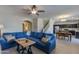 Open concept living room, with view of dining and stairs, features a large blue sectional sofa at 852 E Gary Ln, Phoenix, AZ 85042