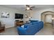 Living room with large blue sectional sofa, media center, and ceiling fan at 852 E Gary Ln, Phoenix, AZ 85042