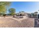 A Large backyard featuring mature trees, an extended patio, and a fenced perimeter at 9618 W Appaloosa Dr, Sun City, AZ 85373