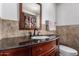 Bathroom featuring dark wood vanity, tile flooring, and shower behind a decorative curtain at 9618 W Appaloosa Dr, Sun City, AZ 85373