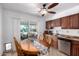 Eat in kitchen featuring wood cabinets, stainless steel appliances, and sliding glass door to back patio at 9618 W Appaloosa Dr, Sun City, AZ 85373