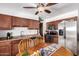 Cozy eat-in kitchen featuring stainless steel appliances, tile flooring, and wood cabinetry at 9618 W Appaloosa Dr, Sun City, AZ 85373