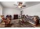 Cozy living room with a ceiling fan, fireplace and comfortable furniture with southwest designs at 9618 W Appaloosa Dr, Sun City, AZ 85373