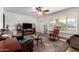 Inviting living room with ample natural light, tile flooring, and a ceiling fan at 9618 W Appaloosa Dr, Sun City, AZ 85373