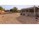 Spacious backyard with gravel and covered patio at 10126 W Sun City Blvd, Sun City, AZ 85351