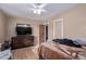 Bright bedroom featuring a large TV and dresser at 10126 W Sun City Blvd, Sun City, AZ 85351