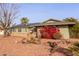 House exterior featuring red flowers and rock landscaping at 10126 W Sun City Blvd, Sun City, AZ 85351