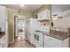 White kitchen with appliances and view to backyard at 10126 W Sun City Blvd, Sun City, AZ 85351