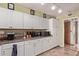 Kitchen with white cabinets, granite counters and appliances at 10126 W Sun City Blvd, Sun City, AZ 85351