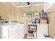 Functional laundry room with washer, dryer and storage at 10126 W Sun City Blvd, Sun City, AZ 85351
