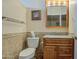 Charming half bathroom features tiled walls, granite counters, and a framed mirror at 1064 S 81St Pl, Mesa, AZ 85208