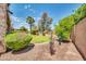 Landscaped backyard with a grassy lawn and a covered patio at 11050 E Ravenna Ave, Mesa, AZ 85212