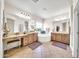 Elegant bathroom with double sinks, soaking tub, and separate shower at 11050 E Ravenna Ave, Mesa, AZ 85212