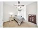 Bedroom with ceiling fan and decorative screen at 11050 E Ravenna Ave, Mesa, AZ 85212