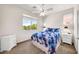 Bright bedroom with a ceiling fan and window at 11050 E Ravenna Ave, Mesa, AZ 85212