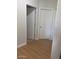Hallway with white doors and trim, plus wood-look floors at 11050 E Ravenna Ave, Mesa, AZ 85212